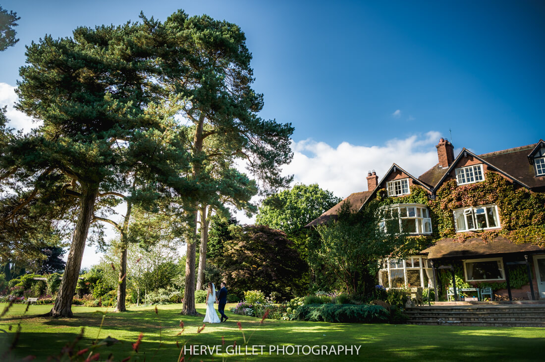 Bride and groom walking in the garden